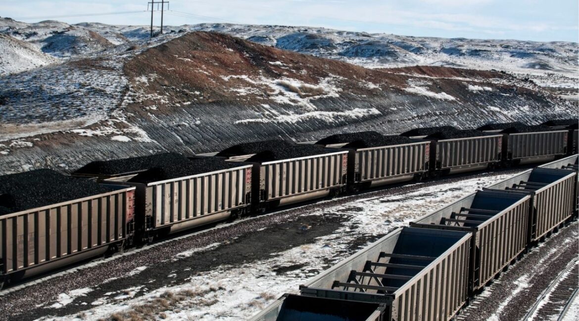 Rail cars are filled with coal and sprayed with a topper agent to suppress dust north of Douglas, Wyo,, Jan. 9, 2014. (AP File)