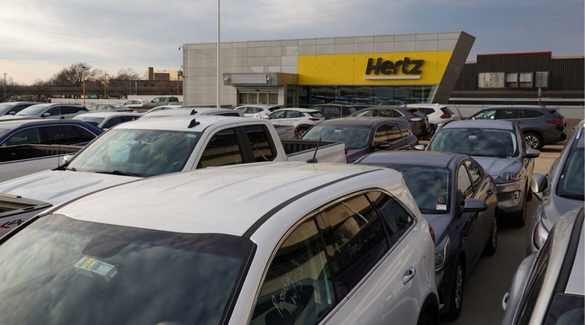 Cars are parked near Hertz car rental signage at John F. Kennedy International Airport in Queens, New York City, U.S., March 30, 2022. (REUTERS/Andrew Kelly)