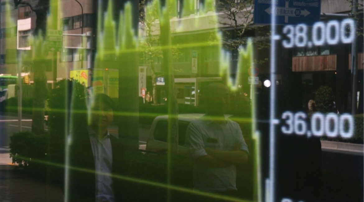 Pedestrians are reflected on a stock quotation board showing a graph of Nikkei share average outside a brokerage in Tokyo, Japan April 14, 2025. (REUTERS File)