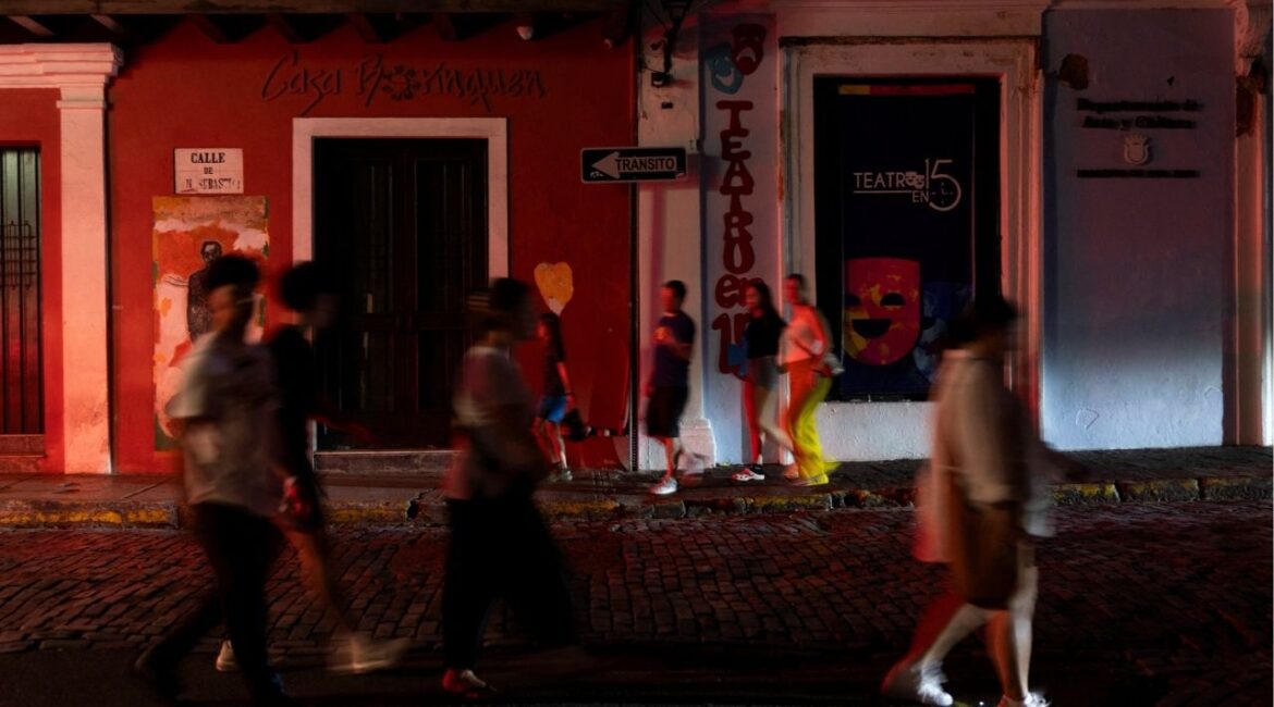 People walk through a dark street after Puerto Rico was hit with a massive power outage where energy plants across the island unexpectedly shut down, in San Juan, Puerto Rico April 16, 2025. (REUTERS/Ricardo Arduengo)