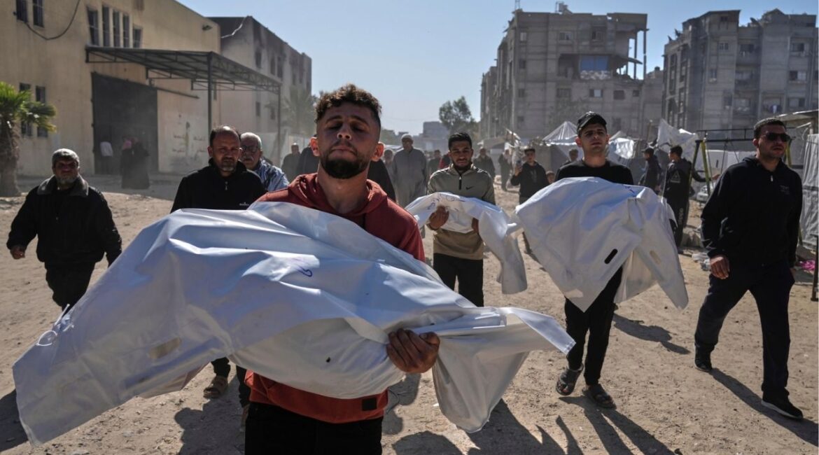 Mourners carry white sacks covering the bodies of members of the Abu Al-Rous family, killed when an Israeli airstrike struck their displacement tent overnight, during their funeral in Khan Younis, southern Gaza Strip, Thursday, April 17, 2025. (AP/Abdel Kareem Hana)