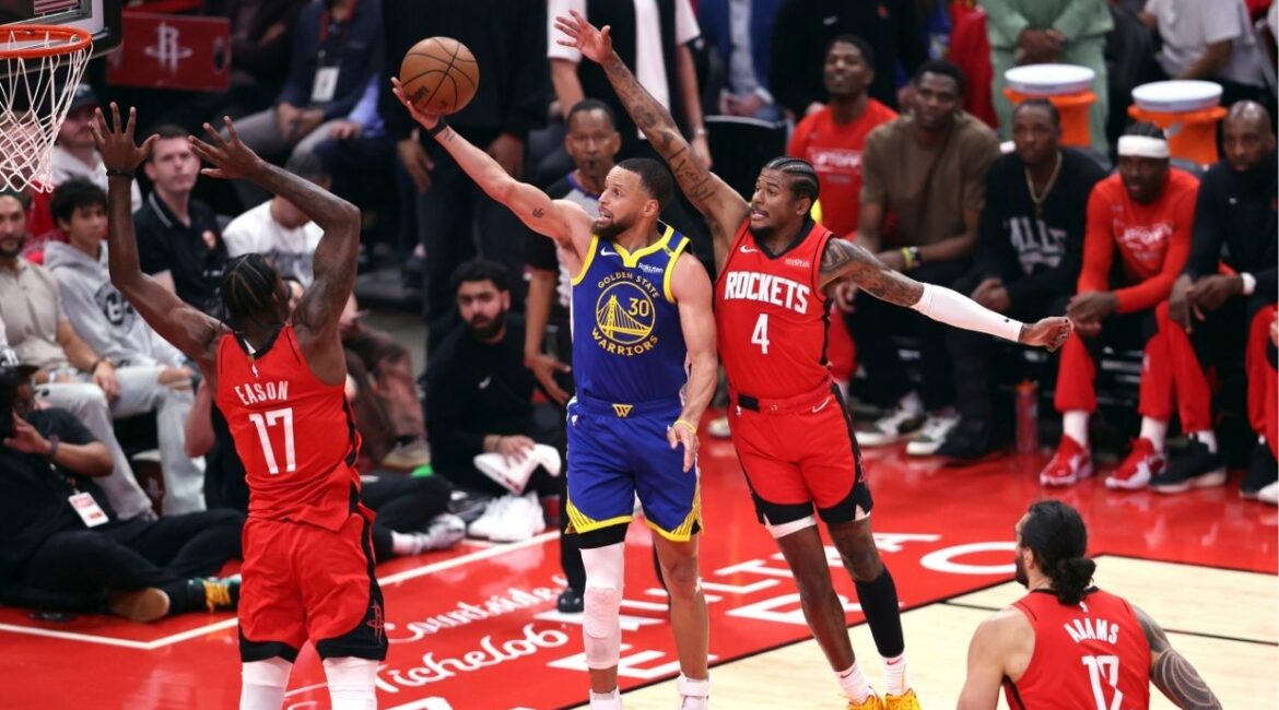 Golden State Warriors' Stephen Curry (30) scores against Houston Rockets' Tari Eason (17) and Jalen Green (4) during the first half of Game 1 of an NBA basketball first-round playoff series in Houston, Sunday, April 20, 2025. (Scott Strazzante/San Francisco Chronicle via AP)