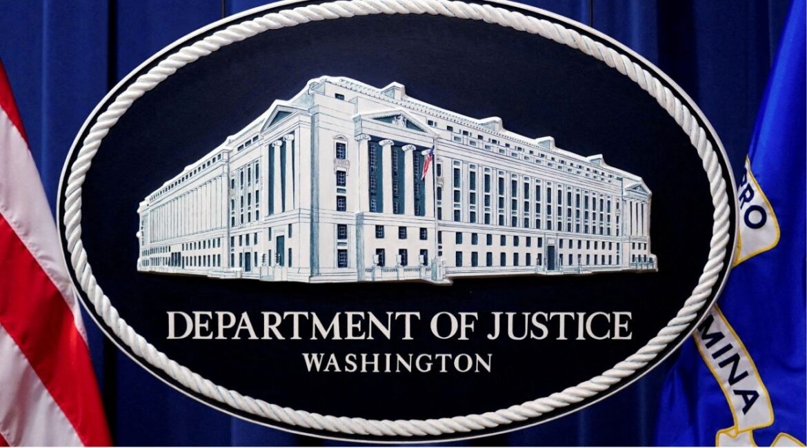 A U.S. Justice Department logo or seal showing Justice Department headquarters, known as "Main Justice," is seen behind the podium in the Department's headquarters briefing room, January 24, 2023. (REUTERS/Kevin Lamarque/File Photo)