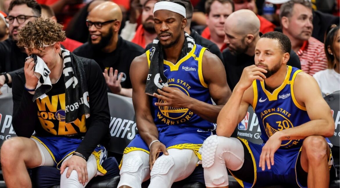 Brandin Podziemksi (2), Jimmy Butler (10) and Stephen Curry (30) react on the bench in the final seconds of the second half as the Golden State Warriors played the Houston Rockets in Game 5 of the First Round of the NBA Playoffs at Toyota Center in Houston, Texas on Wednesday, April 30, 2025. (Carlos Avila Gonzalez/San Francisco Chronicle via AP)