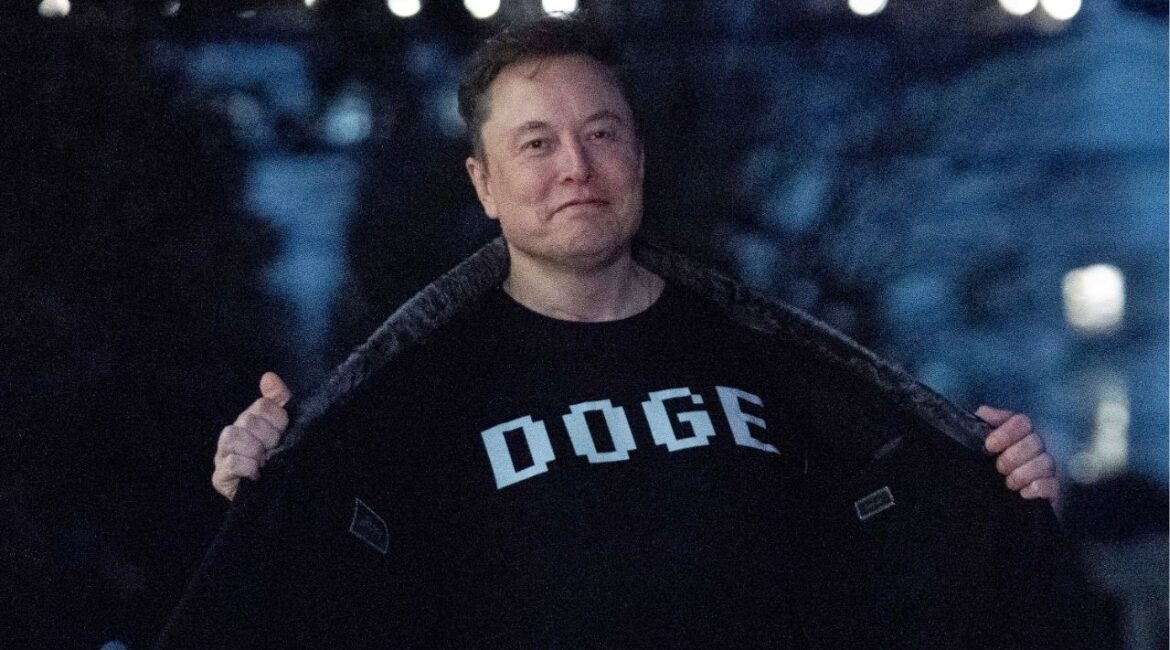 Elon Musk flashes his T-shirt that reads "DOGE" to the media as he walks on South Lawn of the White House, in Washington, March 9, 2025. (AP File)