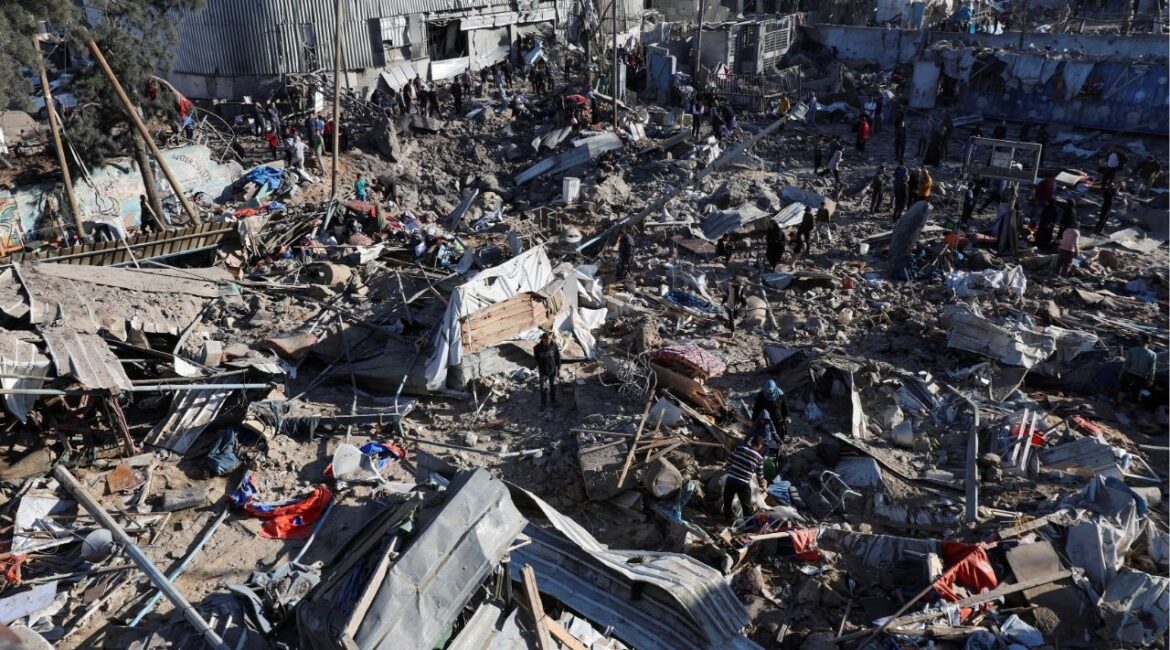 Palestinians inspect the site of an Israeli strike on an UNRWA school sheltering displaced people, in the Bureij camp in the central Gaza Strip, May 7, 2025. REUTERS/Ramadan Abed