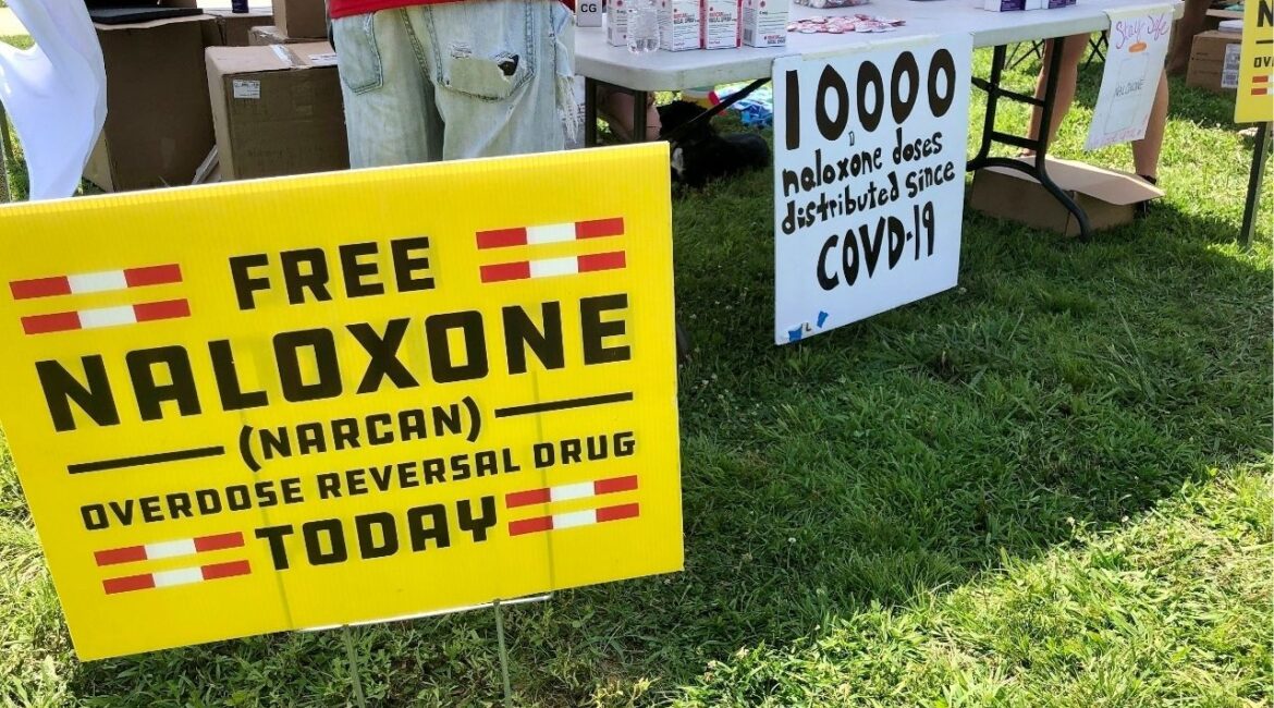 Signs are displayed at a tent during a health event on June 26, 2021, in Charleston, W.Va. (AP File)
