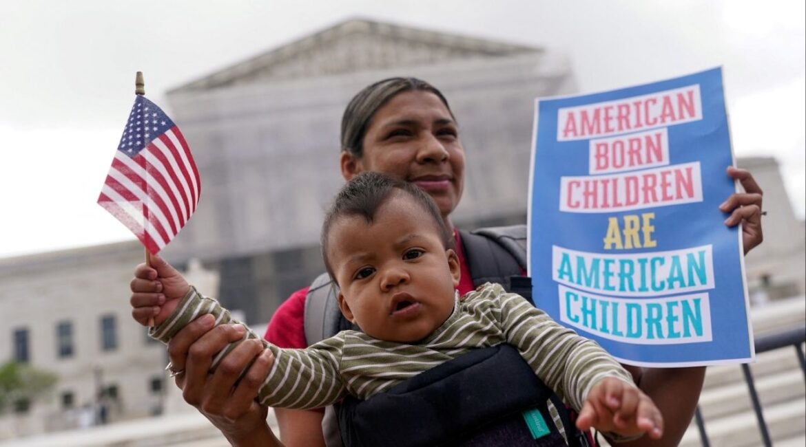 Olga Urbina carries baby Ares Webster as demonstrators rally on the day the Supreme Court justices hear oral arguments over U.S. President Donald Trump's bid to broadly enforce his executive order to restrict automatic birthright citizenship, during a protest outside the U.S. Supreme Court in Washington, D.C., U.S., May 15, 2025. REUTERS/Nathan Howard