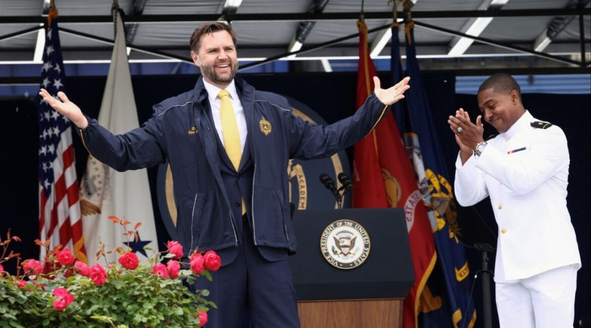 Vice President JD Vance receives a jacket as a gift after speaking at the Graduation and Commissioning Ceremony at the U.S. Naval Academy in Annapolis, Maryland, U.S., May 23, 2025. REUTERS/Kevin Lamarque
