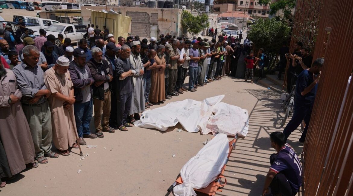 Palestinians pray during the funeral of a person who was killed while heading to a Gaza aid hub, along with three others who were killed during an Israeli strike, as they gather at the Nasser Hospital in Khan Younis, southern Gaza Strip, Sunday, June 1, 2025. (AP/Abdel Kareem Hana)