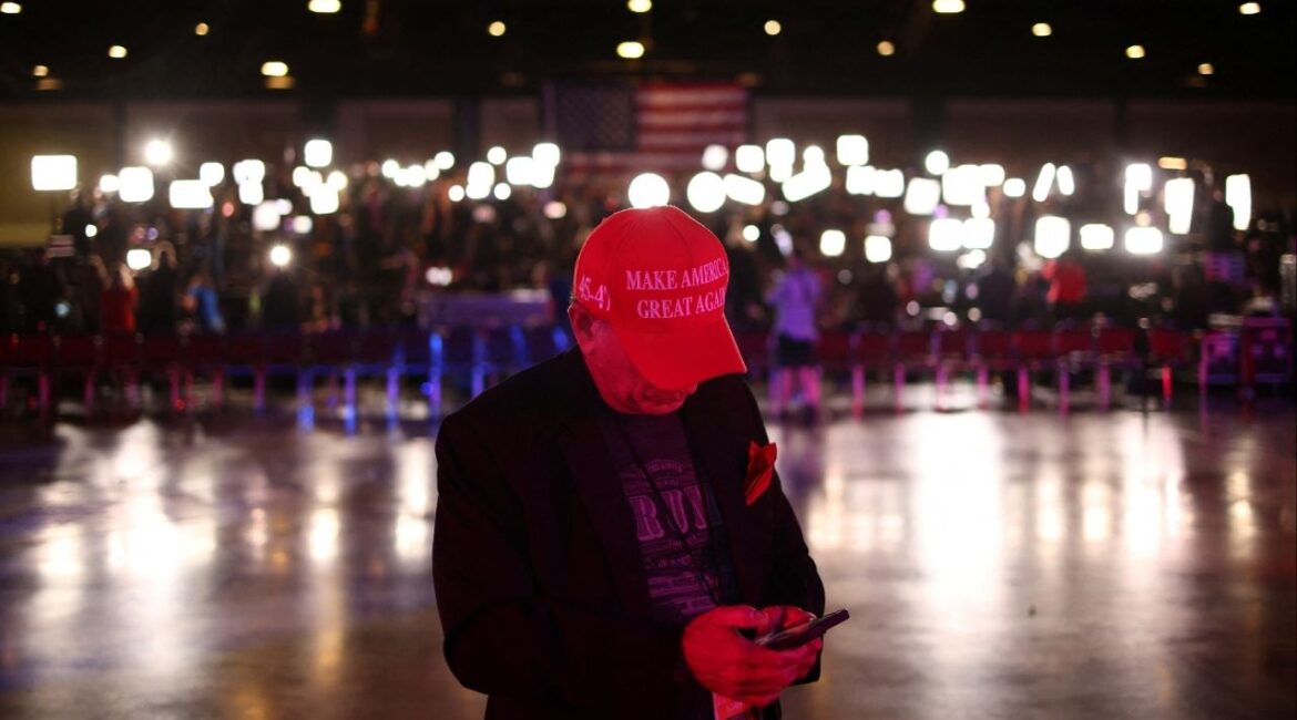 A supporter uses his mobile phone ahead of Republican presidential nominee and former U.S. President Donald Trump's watch party in Palm Beach County Convention Center, in West Palm Beach, Florida, U.S., November 5, 2024. (Reuters File)