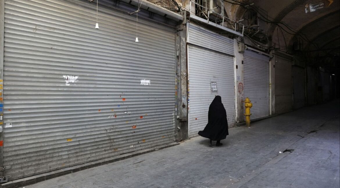 A person walks in front of closed shops in the Tehran Bazaar following the Israeli strikes on Iran, in the center of Tehran, Iran, June 16, 2025. Majid Asgaripour/WANA (West Asia News Agency) via REUTERS