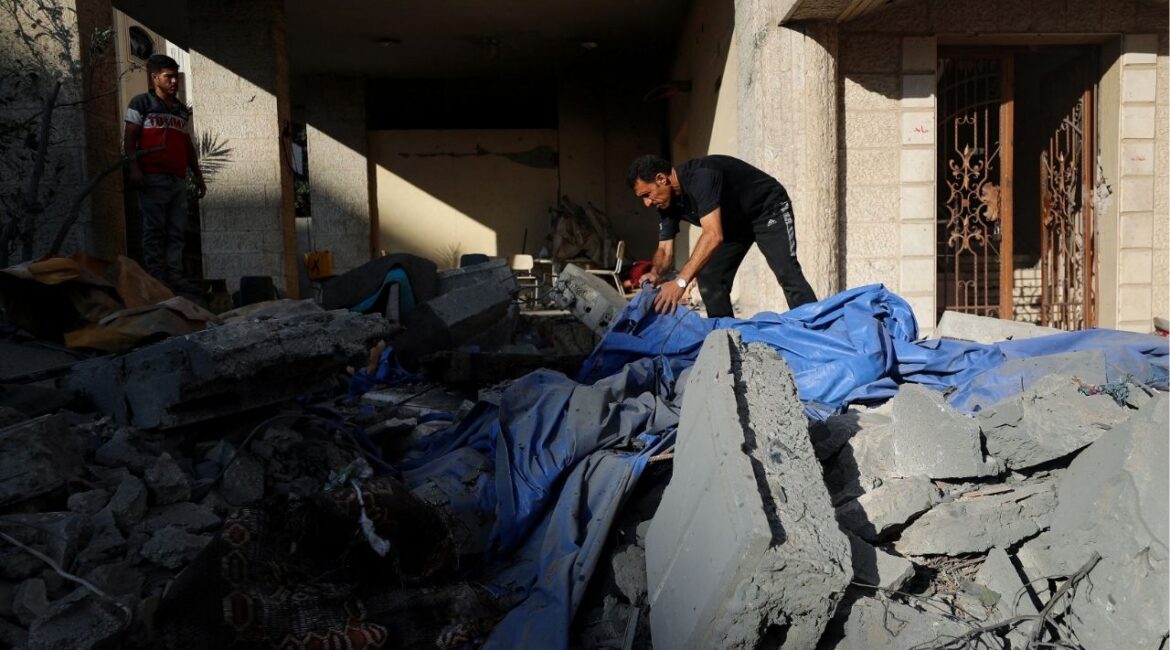 A Palestinian man stands at the site of an overnight Israeli strike on a house in Gaza City, July 8, 2025. REUTERS/Mahmoud Issa