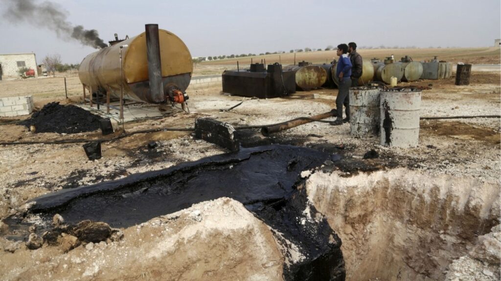 Men work at a makeshift oil refinery site in Marchmarin town, southern countryside of Idlib, Syria December 16, 2015. (Reuters File)