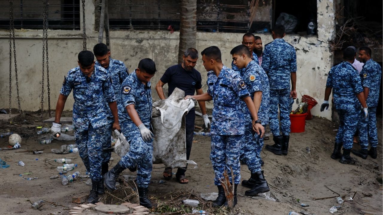 Members of Bangladesh Airforce work at the site, after an air force training aircraft crashed into a building belong to Milestone School and College campus, in Dhaka, Bangladesh, July 22, 2025. REUTERS/Mohammad Ponir Hossain