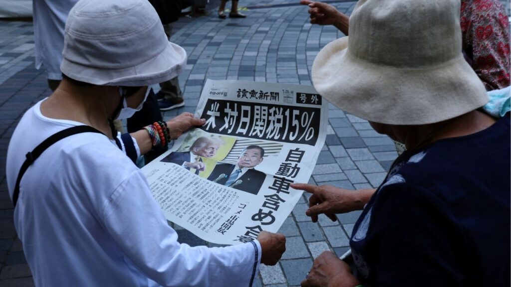 People react as they read a special edition of Yomiuri Shimbun newspaper reporting the tariff deal agreement between U.S and Japan, in Tokyo, Japan, July 23, 2025. (Reuters/Kim Kyung-Hoon)