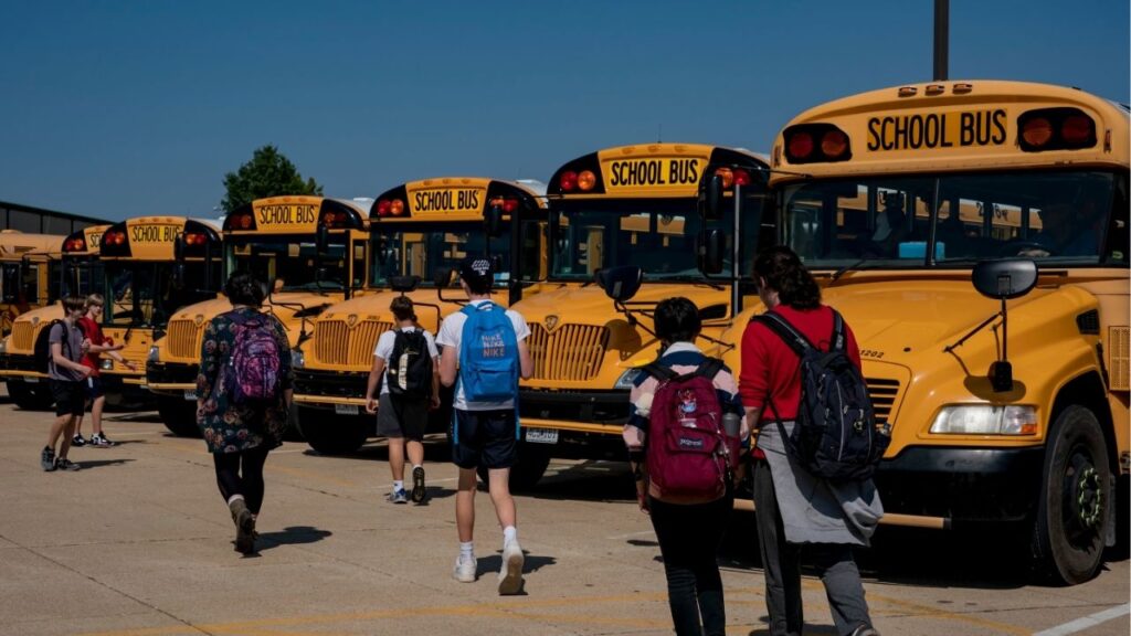 Students head to the buses at the end of the day at a high school in Cedar Hill, Mo., on Sept. 14, 2022. The White House will release $5.5 billion in frozen education funds, administration officials announced on Friday, July 25, bringing an end to a chaotic saga of the administration’s making, which had sent school districts scrambling with weeks to go before the school year. (Whitney Curtis/The New York Times)