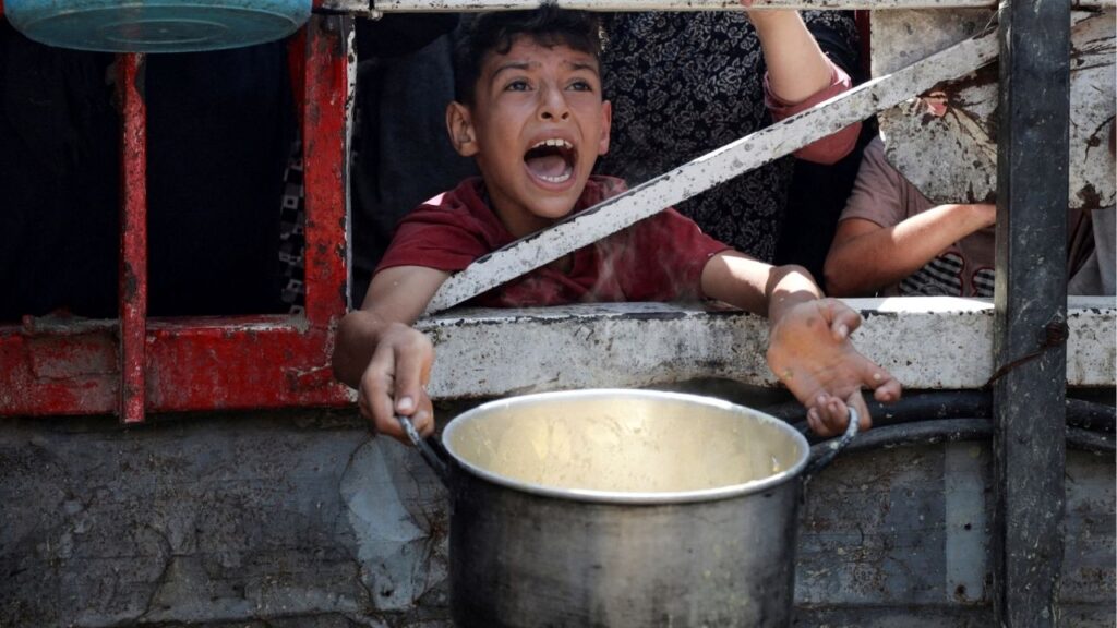 A Palestinian reacts as he waits to receive food from a charity kitchen, amid a hunger crisis, in Gaza City, July 28, 2025. (Reuters/Khamis Al-Rifi)