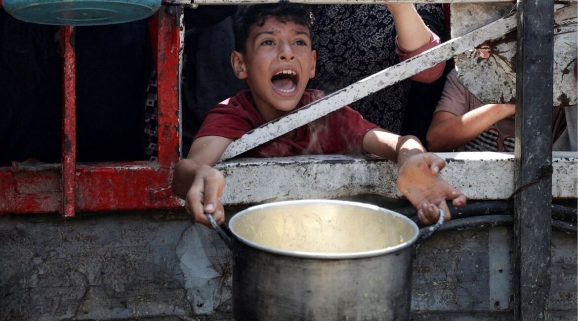 A Palestinian reacts as he waits to receive food from a charity kitchen, amid a hunger crisis, in Gaza City, July 28, 2025. (Reuters/Khamis Al-Rifi)