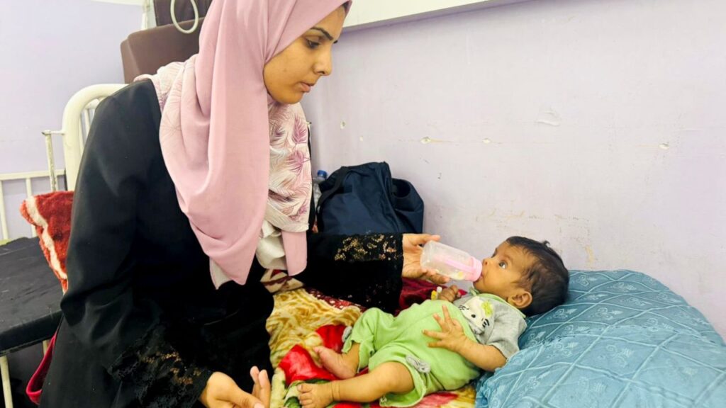 Mother Feeds Her Infant Daughter in central Gaza July 2025