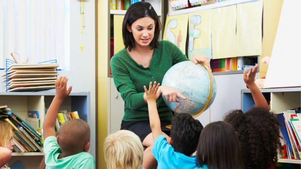 Teacher Uses Globe While Instructing Her Students