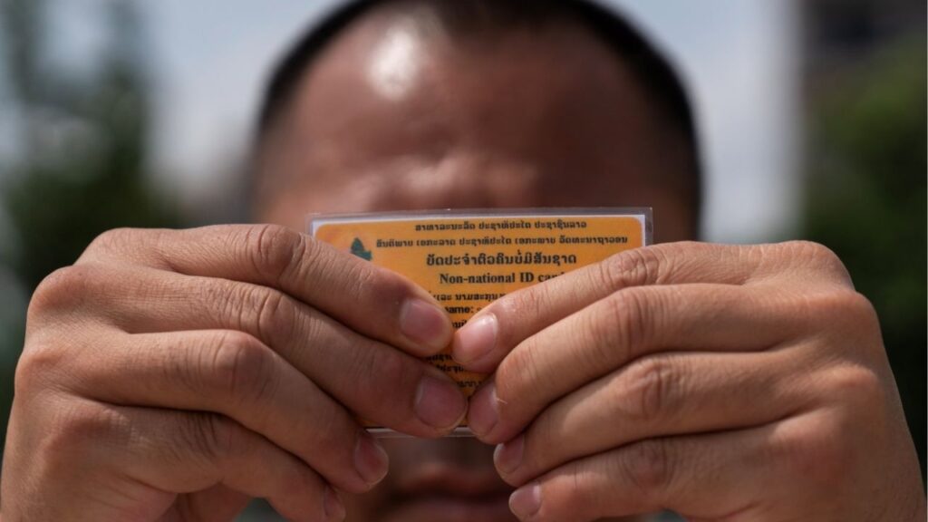 A Lao man deported from the U.S. holds up his non-national ID card - a document that defines his legal status in the country he left behind decades ago, and to which he has now returned, in Vientiane, Laos, July 31, 2025. REUTERS/Phoonsab Thevongsa