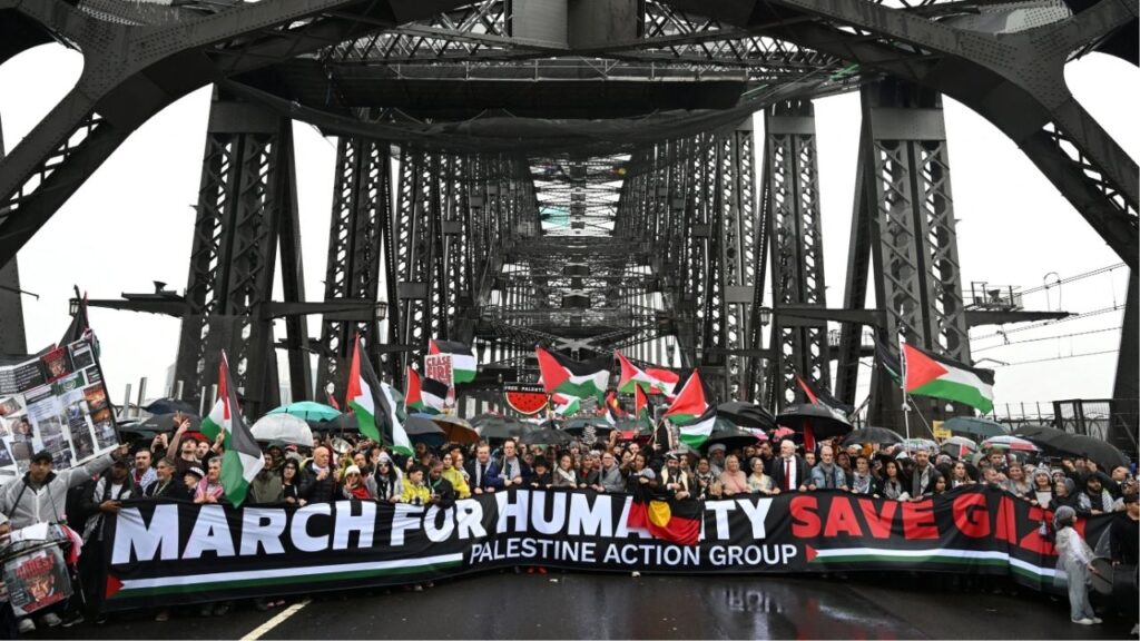 Protesters walk across the Sydney Harbour Bridge during the Palestine Action Group's March for Humanity in Sydney, Australia, August 3, 2025. AAP/Dean Lewins via REUTERS