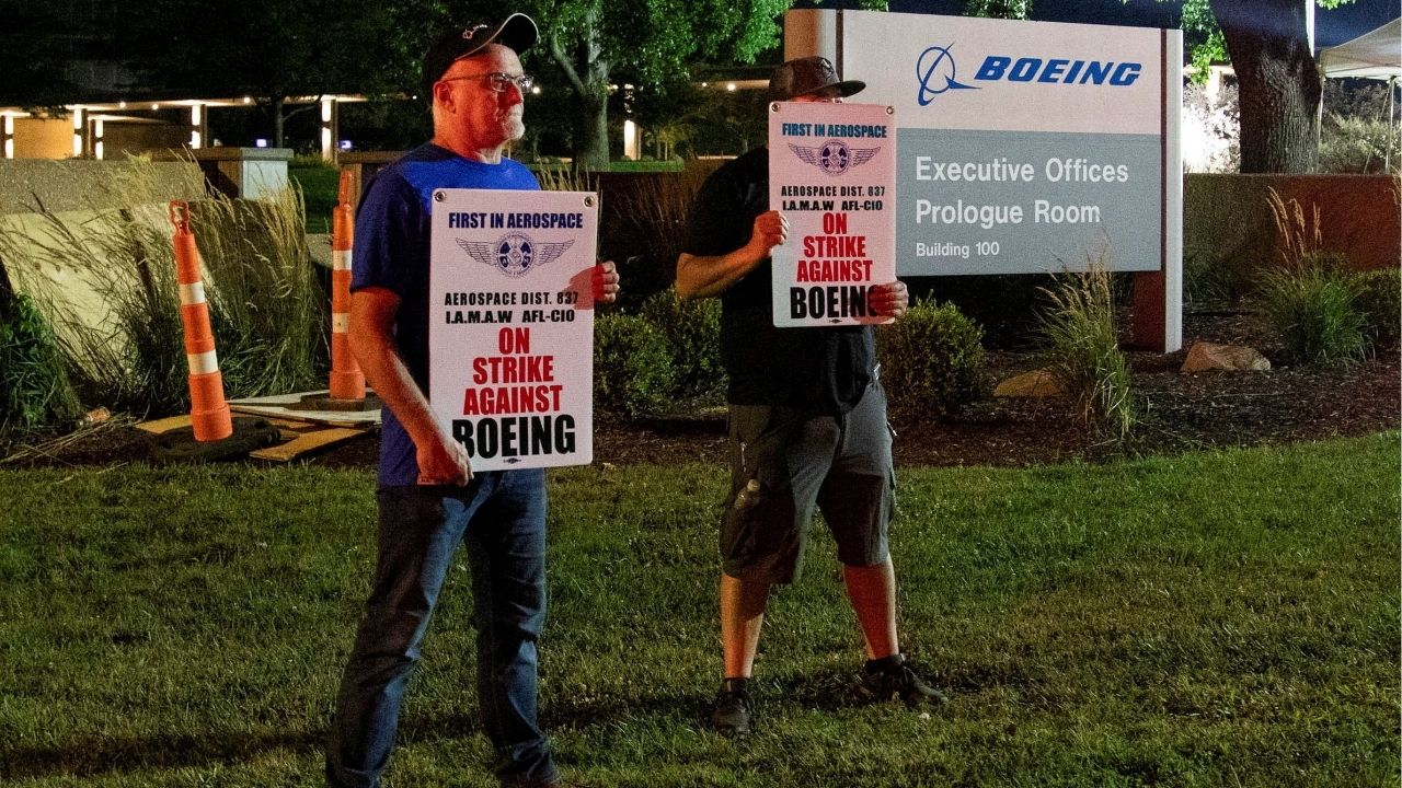 Workers display picket signs, as they protest during a walkout by members of the International Association of Machinists and Aerospace Workers (IAM) over contract negotiations, outside Boeing company's facility, in Berkeley, Missouri, U.S., August 4, 2025 (Reuters/Lawrence Bryant)