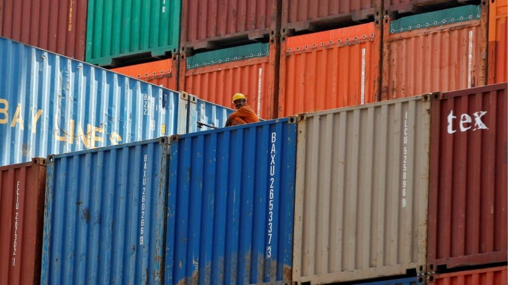 A worker sits on a ship carrying containers at Mundra Port in the western Indian state of Gujarat April 1, 2014. (Reuters File)