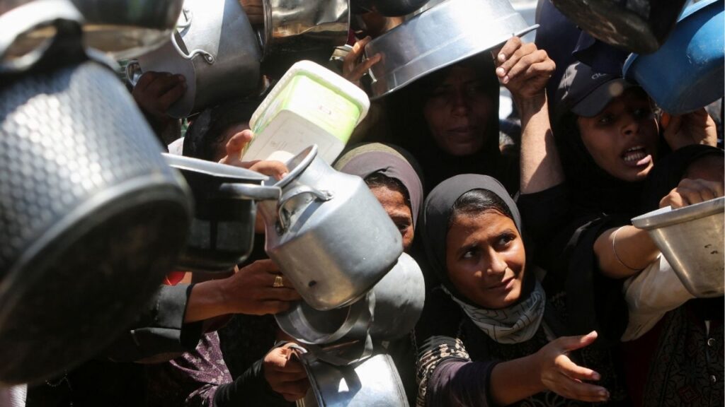 Palestinians wait to receive food from a charity kitchen, amid a hunger crisis, in Khan Younis, southern Gaza Strip, August 4, 2025. (Reuters File)