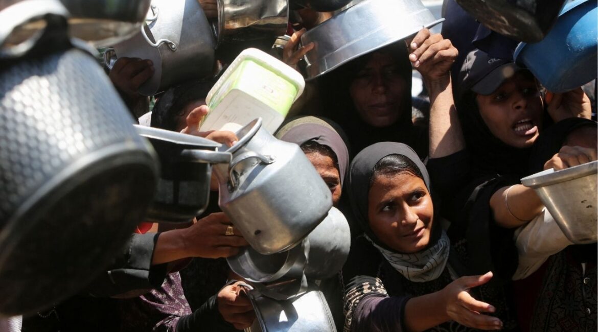 Palestinians wait to receive food from a charity kitchen, amid a hunger crisis, in Khan Younis, southern Gaza Strip, August 4, 2025. (Reuters File)