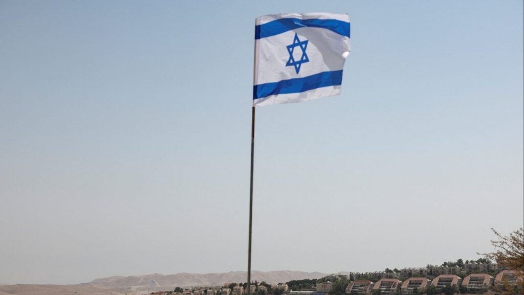 An Israeli flag flutters, as part of the Israeli settlement of Maale Adumim is visible in the background, in the Israeli-occupied West Bank, August 14, 2025. (Reuters File)