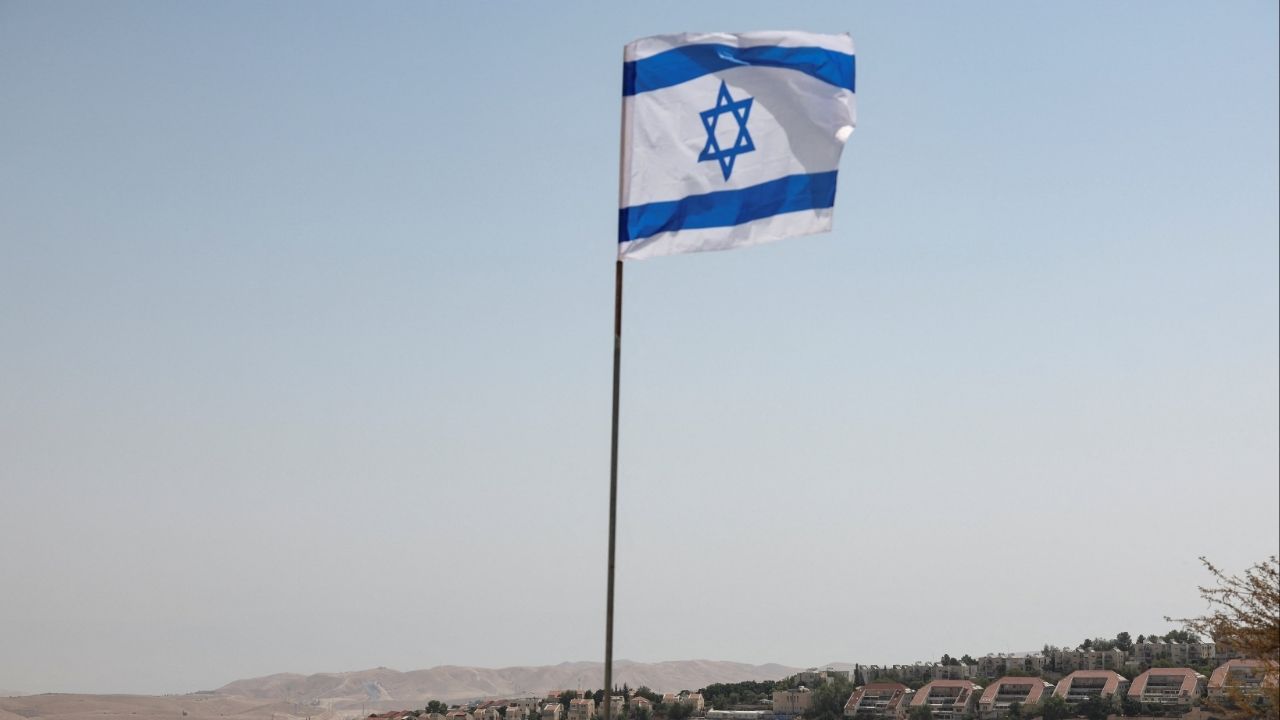 An Israeli flag flutters, as part of the Israeli settlement of Maale Adumim is visible in the background, in the Israeli-occupied West Bank, August 14, 2025. (Reuters File)
