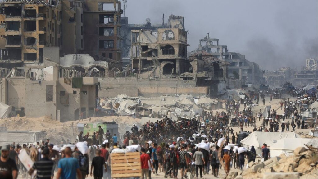 Palestinians carry aid supplies they collected from trucks that entered Gaza through Israel, in Beit Lahia, in the northern Gaza Strip August 10, 2025. (Reuters File)