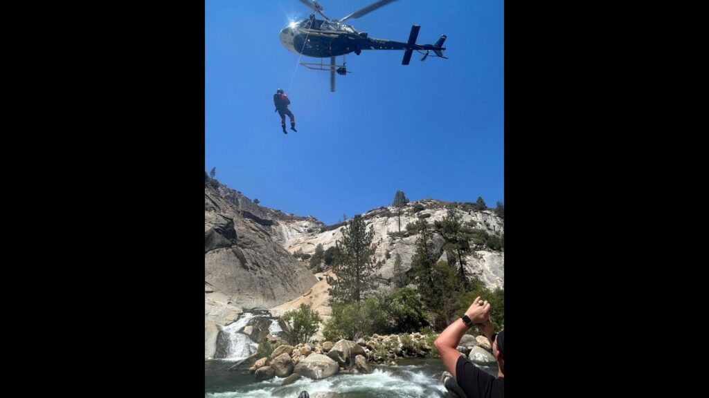In an image from the Tulare County Sheriff’s Office, Ryan Wardwell stands trapped at the Seven Teacups waterfalls in the Sequoia National Forest on Tuesday, Aug. 12, 2025. Wardwell, who was found with minor injuries and suffering from dehydration, was located by rescue crews operating a drone near where he had last been spotted. (Tulare County Sheriff’s Office via The New York Times) In an image from the Tulare County Sheriff’s Office, a California Highway Patrol helicopter hovers over a waterfall where a man was trapped at the Seven Teacups waterfalls in the Sequoia National Forest on Tuesday, Aug. 12, 2025. The man, who was found with minor injuries and suffering from dehydration, was located by rescue crews operating a drone near where he had last been spotted. (Tulare County Sheriff’s Office via The New York Times)