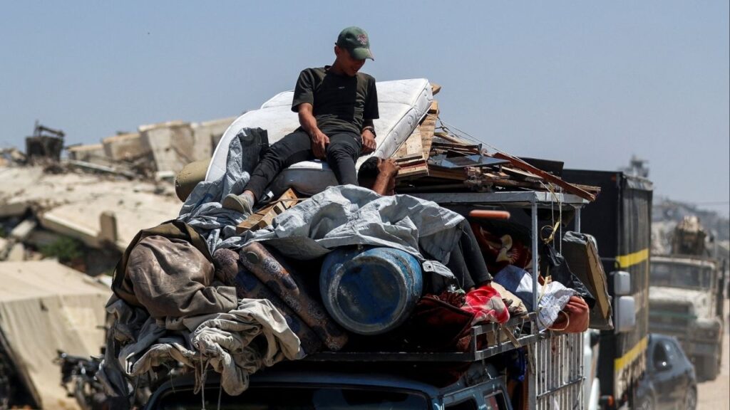 Displaced Palestinians fleeing northern Gaza travel in a vehicle while they head south as the Israeli military prepares to relocate residents to the southern part of the enclave, in Gaza City, August 18, 2025. (Reuters/Mahmoud Issa)