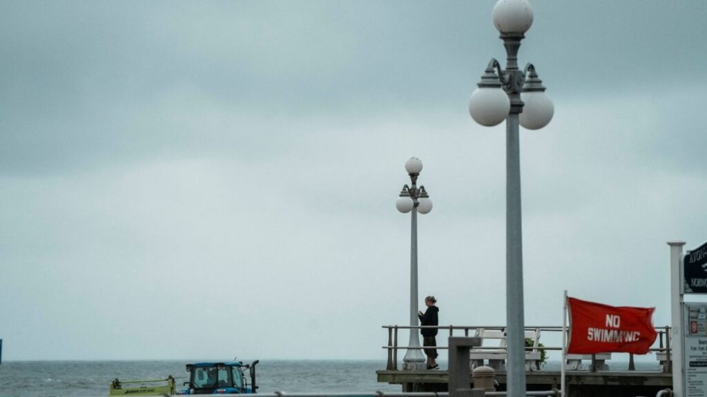 A person stands by the beach during Hurricane Erin, the first hurricane of the 2025 Atlantic season, in Avon-by-the-Sea, New Jersey, U.S., August 20, 2025. (Reuters/Eduardo Munoz)