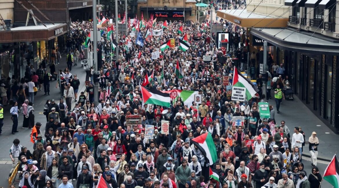 Demonstrators hold placards as they take part in the 'Nationwide March for Palestine' protest in Sydney, Australia, August 24, 2025. REUTERS/Hollie Adams