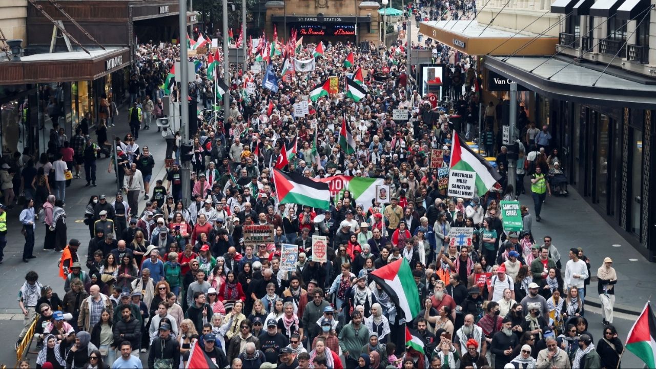 Demonstrators hold placards as they take part in the 'Nationwide March for Palestine' protest in Sydney, Australia, August 24, 2025. REUTERS/Hollie Adams