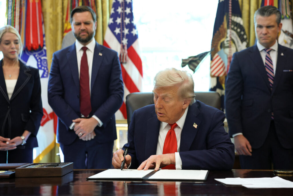 President Donald Trump signs an executive order at the Resolute Desk in the Oval Office of the White House in Washington, D.C., on August 25, 2025.