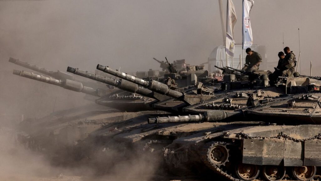 Israeli soldiers sit on top of tanks at the Israel-Gaza border, as seen from Israel, August 26, 2025. (Reuters/Amir Cohen)