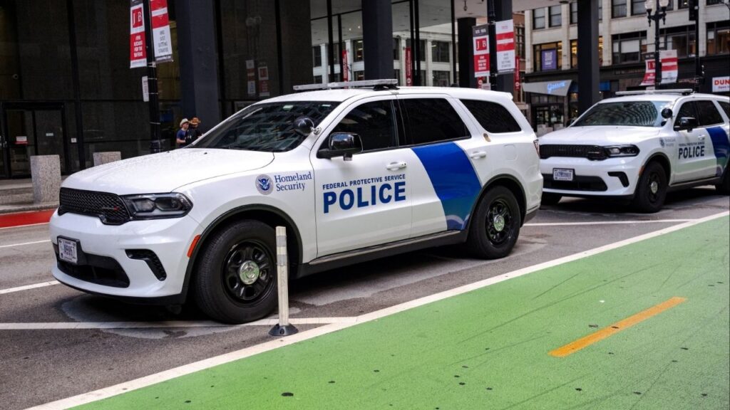 Federal police vehicles belonging to the Department of Homeland Security sit parked next to the Federal Plaza in Chicago, Illinois, U.S., August 26, 2025. U.S. President Donald Trump said on Monday that the U.S. military might deploy to Chicago. (Reuters/ Jim Vondruska)