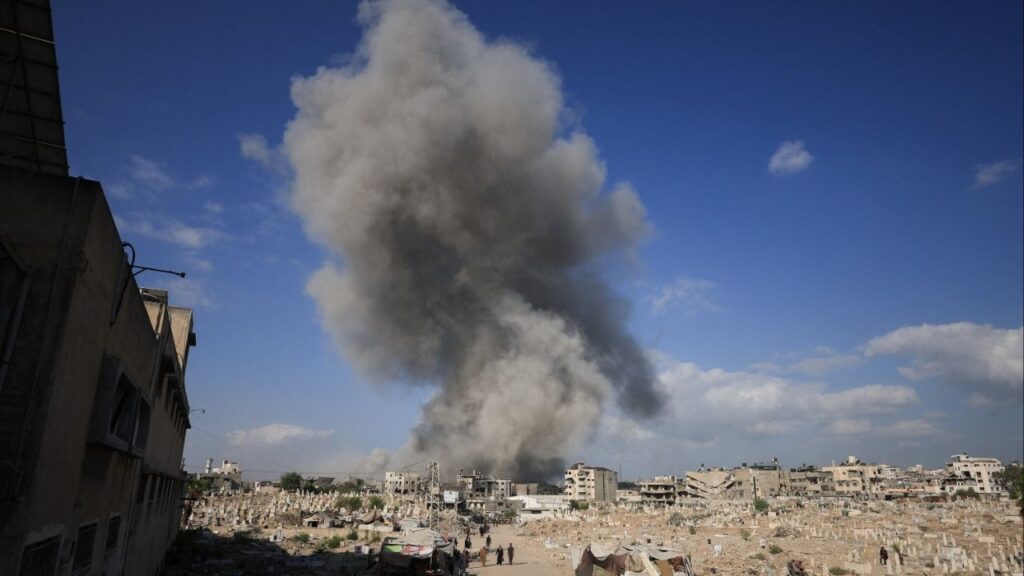 Palestinians gather near a cemetery as smoke rises following an explosion during an Israeli operation in Gaza City, August 28, 2025. (reuters/Dawoud Abu Alkas)