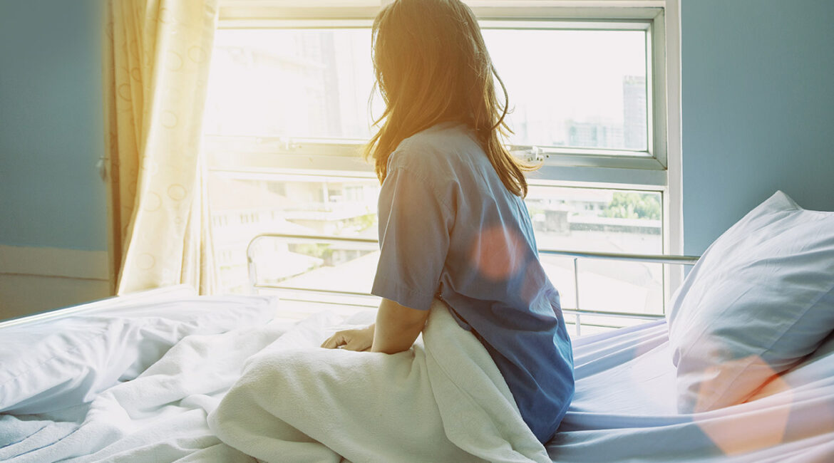 woman looking outside of a hospital
