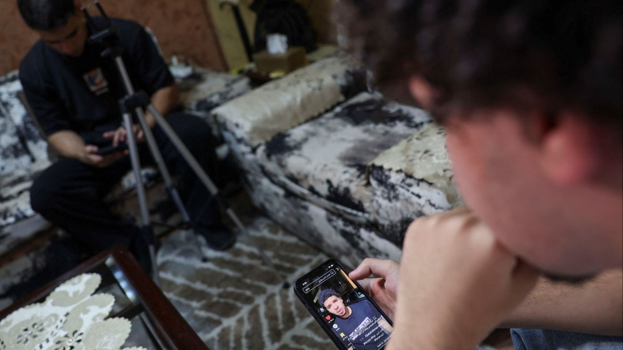 Abdulrahman Hisham, 20, an Egyptian social media content creator, looks at his page with several videos, amid a wave of cases prompting Egypt to consider tighter regulations on social media platforms at his residence in n Cairo, Egypt August, 20, 2025. REUTERS/Amr Abdallah Dalsh