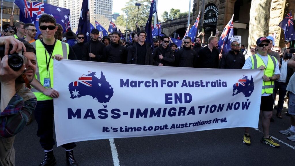 Demonstrators hold a banner during the 'March for Australia' anti-immigration rally, in Sydney, Australia, August 31, 2025. REUTERS/Hollie Adams
